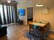 Well-lit dining area with wood-look tile, opening up to a view of the living room and balcony at 5000 Cayview Ave # 10108, Orlando, FL 32819