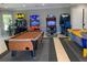 Bright game room featuring a pool table, air hockey, and various arcade game consoles, offering endless entertainment at 5000 Cayview Ave # 10108, Orlando, FL 32819