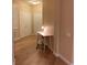 Bright hallway with wood-look tile floors and a minimalist workspace at 5000 Cayview Ave # 10108, Orlando, FL 32819