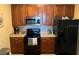 Modern kitchen with black appliances, countertops, and wooden cabinetry at 5000 Cayview Ave # 10108, Orlando, FL 32819