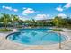 Beautiful community pool featuring a spacious deck with lounge chairs and tables at 5000 Cayview Ave # 10108, Orlando, FL 32819