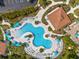 Aerial view of a gorgeous pool with beach umbrellas and lounge chairs at 5000 Cayview Ave # 10108, Orlando, FL 32819