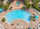 Aerial view of a gorgeous pool with umbrellas and lounge chairs at 5000 Cayview Ave # 10108, Orlando, FL 32819