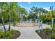 Community splash pad featuring multiple fountains, surrounded by seating, palm trees, and manicured landscaping at 5000 Cayview Ave # 10108, Orlando, FL 32819