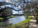 Scenic view of a tranquil pond surrounded by lush greenery and walking paths at 5105 City St # 817, Orlando, FL 32839