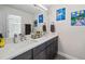 Bright bathroom with a double sink vanity, quartz countertops and modern lighting at 5140 Honeynut Ln, Windermere, FL 34786