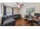 Bedroom with wood floor, fan, closet and window dressed with curtain at 5140 Honeynut Ln, Windermere, FL 34786