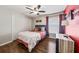 Bedroom with closet, wood flooring, fan and window with dark red curtains at 5140 Honeynut Ln, Windermere, FL 34786