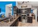 The kitchen features granite countertops, stainless appliances, dark cabinets, and modern lighting at 5140 Honeynut Ln, Windermere, FL 34786