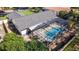 A screened-in pool is surrounded by a patio and lush landscaping at 5140 Honeynut Ln, Windermere, FL 34786