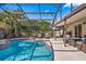 Beautiful in-ground pool surrounded by screen enclosure, patio and outdoor furniture at 5140 Honeynut Ln, Windermere, FL 34786