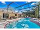 Beautiful in-ground pool surrounded by screen enclosure, patio, plants and outdoor furniture at 5140 Honeynut Ln, Windermere, FL 34786