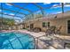 Beautiful in-ground pool surrounded by screen enclosure, patio and outdoor furniture at 5140 Honeynut Ln, Windermere, FL 34786