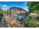 A screened-in pool with outdoor seating surrounded by lush landscaping at 5140 Honeynut Ln, Windermere, FL 34786