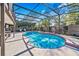 A screened-in pool area with lounge chairs, decorative tiling, and space for outdoor entertaining at 5140 Honeynut Ln, Windermere, FL 34786