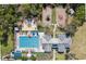 Overhead photo of a community pool, playground, and clubhouse surrounded by lush greenery at 520 Longmeadow St, Celebration, FL 34747