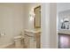 Charming powder room featuring an ornate mirror, unique lighting fixture, and detailed vanity at 520 Longmeadow St, Celebration, FL 34747