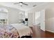 Bedroom with hardwood floors, windows, and a doorway leading to the upper hallway at 520 Longmeadow St, Celebration, FL 34747