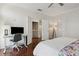 Bedroom featuring a desk, hardwood floors, and a doorway leading to the hallway at 520 Longmeadow St, Celebration, FL 34747