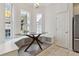 Bright breakfast nook with modern table, custom bench seating, and large windows providing ample natural light at 520 Longmeadow St, Celebration, FL 34747