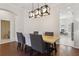 Contemporary dining room with sleek lighting, hardwood floors, and dining table with upholstered chairs at 520 Longmeadow St, Celebration, FL 34747