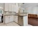 A modern kitchen featuring stainless steel appliances, granite countertops, and pristine white cabinetry at 520 Longmeadow St, Celebration, FL 34747