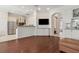 Spacious living room showcasing a wet bar and an open layout leading into a bright kitchen at 520 Longmeadow St, Celebration, FL 34747