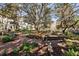 Scenic park featuring a fountain, benches, mature trees, and a red brick walkway. It's a tranquil outdoor space at 520 Longmeadow St, Celebration, FL 34747