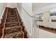 Elegant staircase features wood steps, white railing and beautiful decorative patterned stair runner at 520 Longmeadow St, Celebration, FL 34747