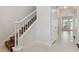 Traditional staircase featuring white banisters, carpeted steps, and a view into the living area at 520 Longmeadow St, Celebration, FL 34747