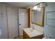 Bathroom featuring a vanity with a sink, a mirror, a closet, and wall shelves at 524 Georgetown Dr # A, Casselberry, FL 32707