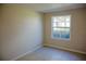 Bedroom featuring tile flooring, neutral walls, and a bright window overlooking the yard at 524 Georgetown Dr # A, Casselberry, FL 32707