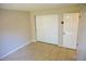 Bright bedroom featuring neutral walls, tile flooring, a closet, and a door at 524 Georgetown Dr # A, Casselberry, FL 32707