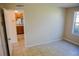 Bedroom featuring tile flooring and a view into the kitchen with wooden cabinets at 524 Georgetown Dr # A, Casselberry, FL 32707