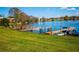 Lakeside dock with a boat, green lawn, and neighborhood views at 524 Georgetown Dr # A, Casselberry, FL 32707