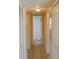 Well-lit hallway featuring tile flooring and white doors, leading to other rooms in the home at 524 Georgetown Dr # A, Casselberry, FL 32707