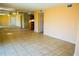 Open-concept living space features tile flooring, neutral walls, and a glimpse of the adjacent kitchen area at 524 Georgetown Dr # A, Casselberry, FL 32707