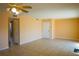 Inviting living room featuring a ceiling fan, neutral paint, and tile flooring, with doors leading to other rooms at 524 Georgetown Dr # A, Casselberry, FL 32707