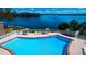 View of sparkling pool and lake from above at 524 Georgetown Dr # A, Casselberry, FL 32707