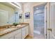 Bathroom featuring double vanity, granite counters, and a walk-in shower at 6090 Broad Oak Dr, Davenport, FL 33837