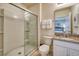 Well-lit bathroom featuring a glass-enclosed shower, granite countertop and vanity with a sink at 6090 Broad Oak Dr, Davenport, FL 33837