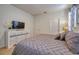 Comfortable bedroom featuring a dresser, a television, and soft, neutral tones at 6090 Broad Oak Dr, Davenport, FL 33837