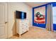 Bright bedroom with a Captain America theme, featuring a TV and a vibrant character poster at 6090 Broad Oak Dr, Davenport, FL 33837