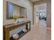 Hallway with tiled floor, console table with a large mirror, and view into the living room at 6090 Broad Oak Dr, Davenport, FL 33837