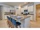 Kitchen island with granite countertop, seating for four, and white cabinets at 6090 Broad Oak Dr, Davenport, FL 33837