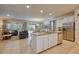 Open-concept kitchen with stainless steel appliances, granite countertops and connection to the living and dining area at 6090 Broad Oak Dr, Davenport, FL 33837