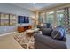 Comfortable living room featuring stylish sofas, a flat screen tv and natural light from the large window at 6090 Broad Oak Dr, Davenport, FL 33837