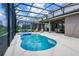 Relaxing screened pool with a hot tub, lounge chairs and a covered seating area with a table and chairs at 6090 Broad Oak Dr, Davenport, FL 33837