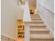 Carpeted staircase with white railings, providing a seamless transition between levels in the home at 6090 Broad Oak Dr, Davenport, FL 33837