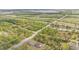 Distant aerial view of the property showcasing the large lot and surrounding wooded area at 6346 Dallas Blvd, Orlando, FL 32833